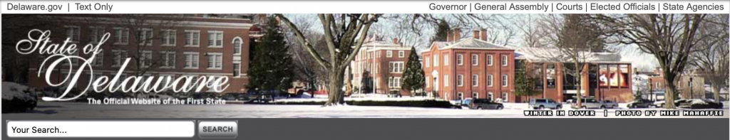 A Delaware website banner with an image of buildings. The text reads State of Delaware, the Official Website of the First State. 