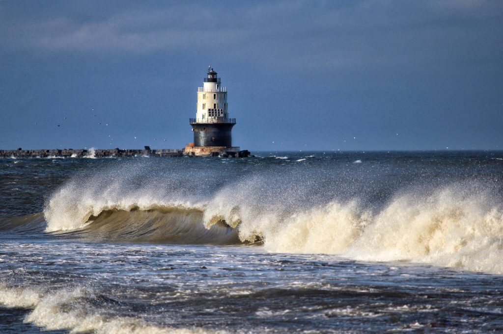 Waves crashing in front of the Harbor of Refuge Lighthouse in Lewes, Delaware.