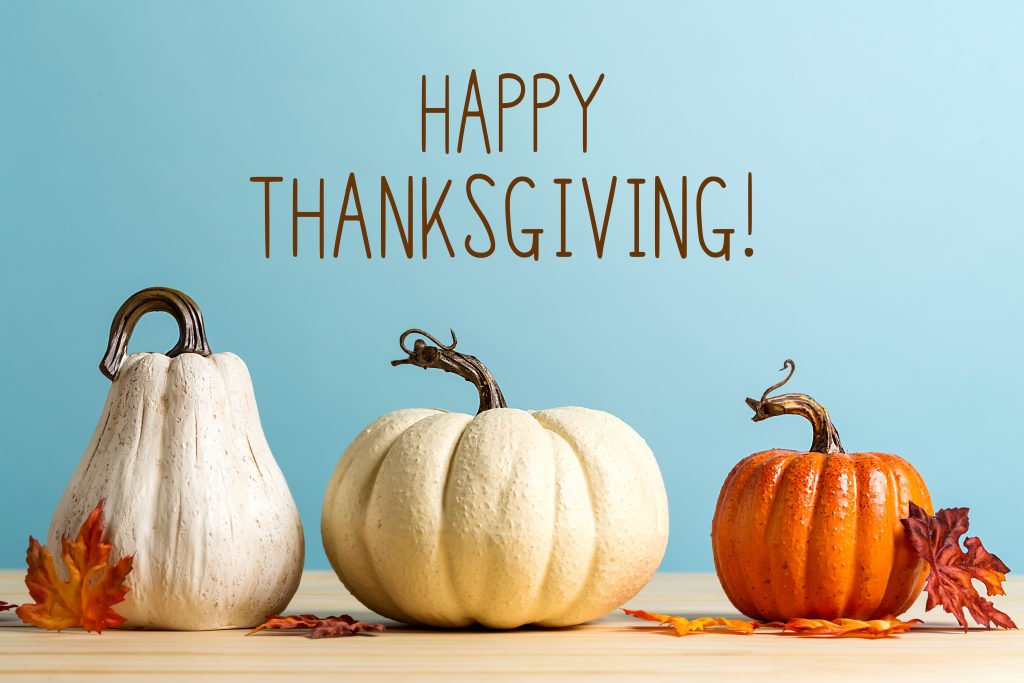 Happy Thanksgiving message with gourds on a blue background.